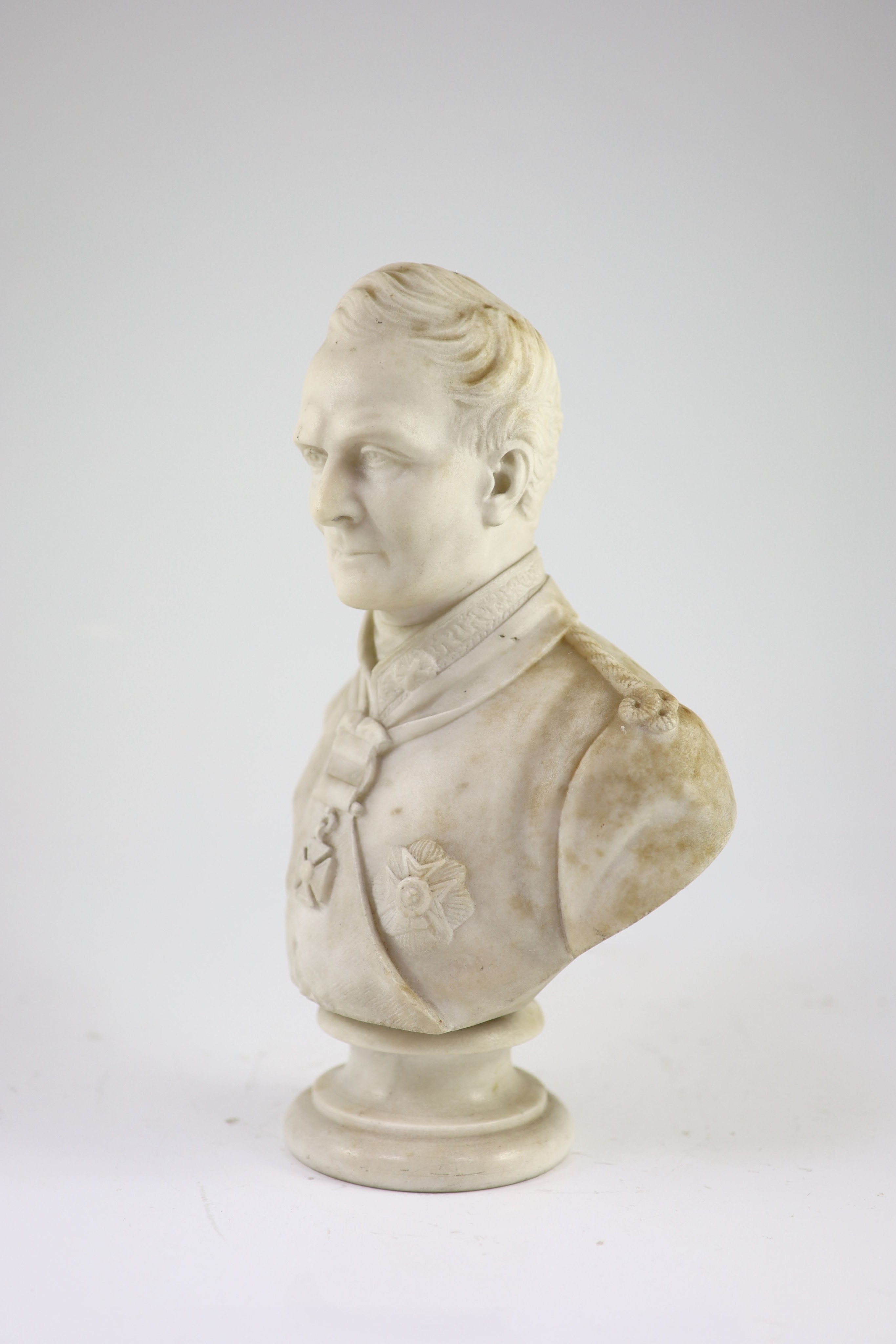 A mid 19th century marble bust of a British Peninsular War army officer wearing the Army Gold Cross and Garter Star, 34cm high